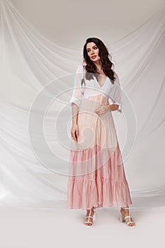 Beautiful sexy woman wear light pink multicolor dress summer collection silk casual style tanned body brunette hair beautiful face