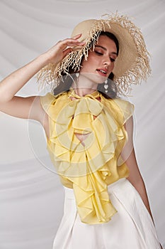 Beautiful sexy woman wear yellow silk blouse white short accessory straw hat summer collection cotton casual style tanned body