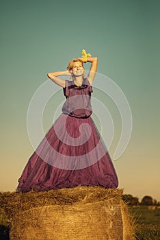 Beautiful young woman in the hay