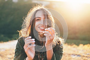 Beautiful sexy young woman smiling on beautiful landscape in sunset time