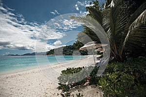 Beautiful seychelles island, ocean shore with white sand and blue sky