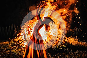 beautiful shamanic woman dancing by the fire.