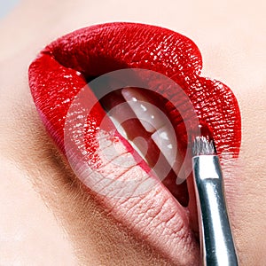 Beautiful shiny red lips as you paint brush