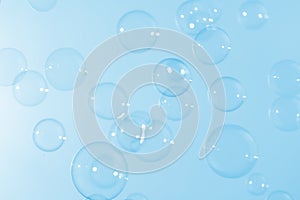 Beautiful shiny transparent soap bubbles float on blue texture background. Abstract, Celebration, Natual fresh summer.