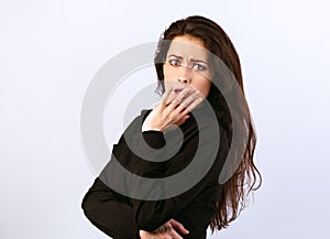 Beautiful shock surprising brunette business woman looking with open mouth covering the hand and big eyes in black cotton shirt