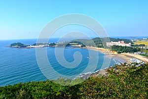 Beautiful shot of the beach and a white building on the hill in Byeonsan-Bando National Park photo