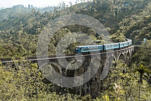 Beautiful shot of a blue train on the Nine Arch Bridge in Sri Lanka