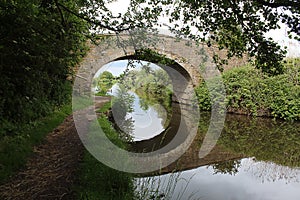 A beautiful shot of a bridge over the Leeds and Liverpool Canal, the reflection can be seen in the water