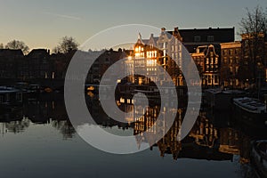 Beautiful shot of the buildings of the city of Amsterdam, the Netherlands during the sunrise
