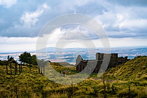 Beautiful shot of the castle-like building's ruins in the middle of the field