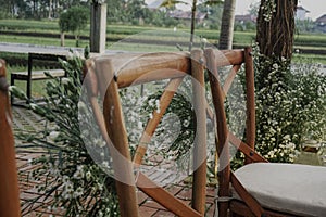 Beautiful shot of the chairs in a decorated open-air wedding reception