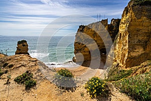 Beautiful shot of the cliffs and the beach of Praia dos Estudiantes in Algarve, Portugal photo