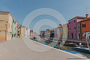 Beautiful shot of colorful houses and a canal in Burano island on a sunny day near Venice, Italy