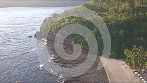 Beautiful shot from drone flying above the sea over tropical paradise beach in the island of Bali in Indonesia in exotic travel