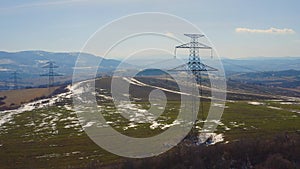 Beautiful shot of electricity post transmission power line on a large farmland