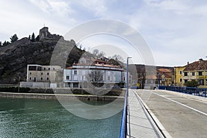 Beautiful shot of an empty bridge, houses, and Zrmanja river in Obrovac Croatia under a clear sky