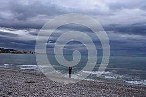 Beautiful shot of a fisherman on a beach on a cloudy sky background