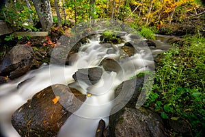 Beautiful shot of the flowing rocky McGillvary Falls in Whiteshell Provincial Park, Manitoba photo