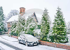 Beautiful shot of frosted landscapes, a house, and a vehicle in the Albrighton Village in England