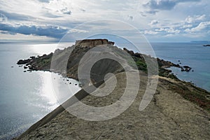 Beautiful shot of the Gnejna bay beach in Malta on a gloomy day photo