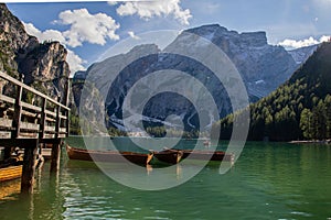 Beautiful shot of a group of boats on calm water in the Fanes-Sennes-Braies Nature Park in Italy photo