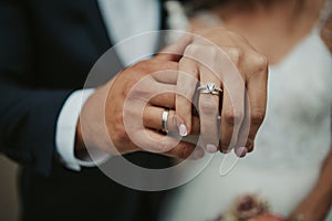 Beautiful shot of the hands of a bride and groom showing their rings - wedding, anniversary
