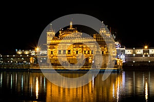 Beautiful shot of the Harmandir Sahib's building on a reflective lake foreground in India