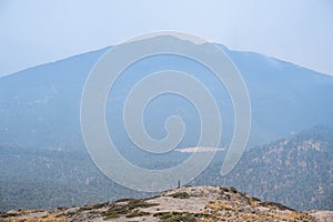 Beautiful shot of a Hispanic hiker on top of mount Tlaloc in Mexico