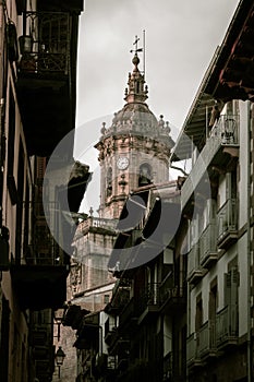 Beautiful shot of the Hondarribia cathedral between buildings photo