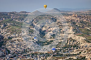 Beautiful shot of the hot air balloons over a landscape in the Cappadocia area in Turkey