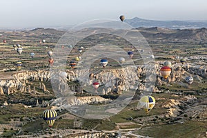 Beautiful shot of the hot air balloons over a landscape in the Cappadocia area in Turkey