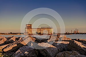 Beautiful shot of an industrial factory located on the shore of a river captured during the sunset