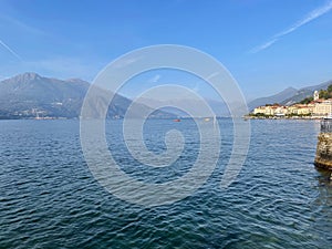Beautiful shot of Lake Como and mountains around under blue sky in Lombardy, Italy