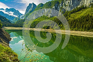 Beautiful shot of the Lake Gosausee surrounded by the  Austrian Alps on a bright day