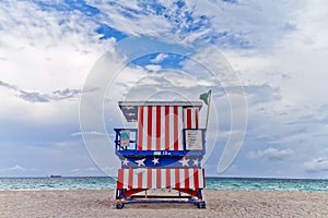Beautiful shot of a lifesaver booth colored in USA flag colors at a beach