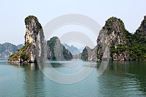 Beautiful shot of limestone islands topped by rainforests in water in Ha Long Bay, Vietnam