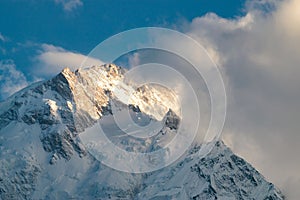 Beautiful shot of nanga parbat mountain peak and clouds covering a part of it in pakistan