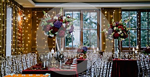 Beautiful shot of a nice elegant red table setting for a party, decorated with candles and flowers