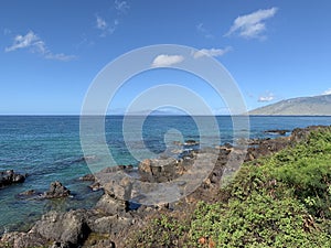 Beautiful shot of pacific ocean view with black volcanic rock beach on the Island of Maui, Hawaii