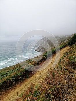 Beautiful shot of a path stretching along the seashore, mesmerizing view in Cangas