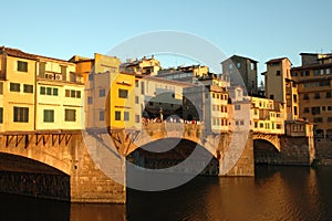 Beautiful shot of people standing on the bridge over the water near buildings