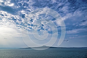 Beautiful shot of the Rangitoto island under a blue cloudy sky in Auckland, New Zeland