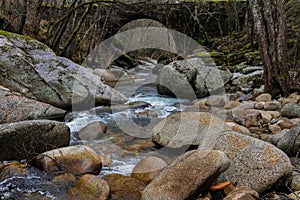 Beautiful shot of river flowing through rocks in Batuecas Natural Park, Spain photo