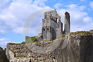 Beautiful shot of the ruins of Corfe Castle under blue sky and white clouds