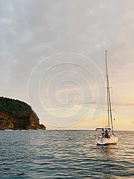 Beautiful shot of a sailing boat with a beautiful sunset view on behind