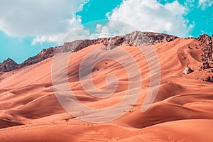 Beautiful shot of sand dunes under a bright sky on the desert in Dubai, UAE