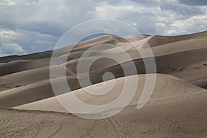 Beautiful shot of sand dunes under the cloudy skies