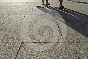 Beautiful shot of the shadows of two people walking on the ground