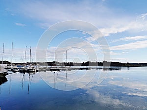 Beautiful shot of ships at the harbor under a blue cloudy sky in Norway