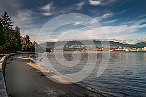 Beautiful shot of the sidewalk near the lake in the Stanley Park in Vancouver, Canada